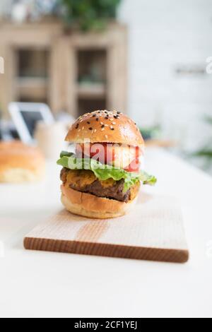 Close up cheeseburger slider on cutting board Stock Photo