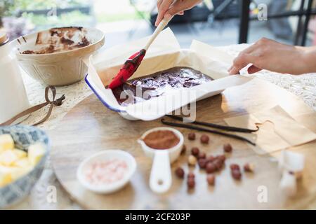 Woman baking chocolate brownies in kitchen Stock Photo