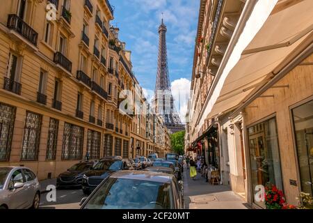 France. Summer Paris. Sunny day. Many cars on the narrow street. Eiffel Tower in the background.
