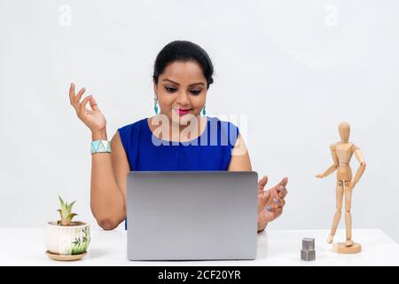 Pretty Indian woman at the table,  Freelancer, distant work, work at home, online education, Office work at home, smiling, happy and excited. Stock Photo