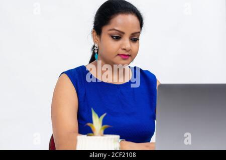 Pretty Indian woman at the table,  Freelancer, distant work, work at home, online education, Office work at home, smiling, happy and excited. Stock Photo