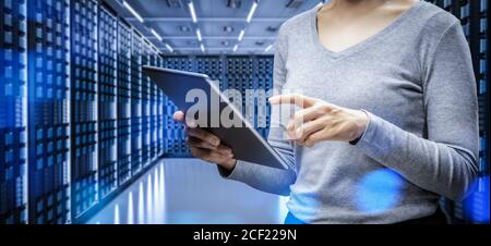 Female programmer with digital tablet in server room Stock Photo