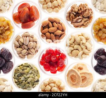 Seamless food background made of nuts, dried berries and dry fruits on white.