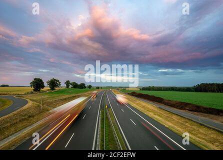 Heavy traffic on the highway during sunset after heavy rain Stock Photo