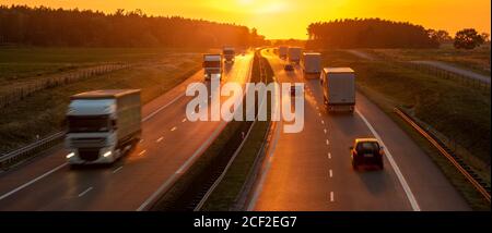Heavy traffic on the highway during sunset after heavy rain Stock Photo