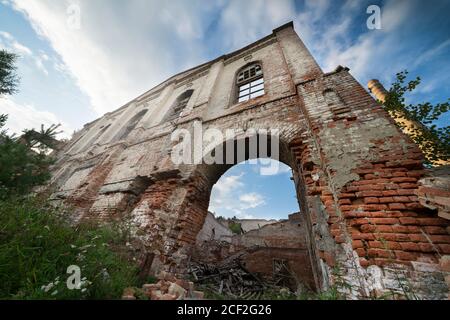 arch of an old ruined brick building against the blue sky Stock Photo