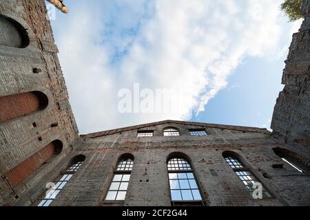 blue sky and walls of an old brick building with a ruined roof Stock Photo