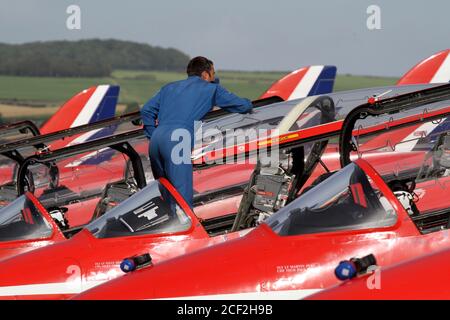 Prestwick, Ayrshire, Scotland, 31 Aug 2013 Red Arrows display team land at Prestwick to refuel enroute to Port Rush air display. Lined up perfectly as crew check the aircraft and prepare for display, Pilots & support crew Stock Photo