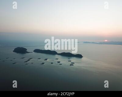 Aerial view Pulau Aman, Pulau Betong in sunset. Background is Penang Second Bridge. Stock Photo