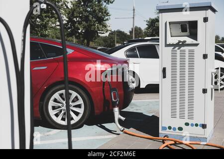 Charging modern electric car on the parking. Stock Photo