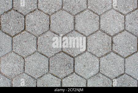 road paved with hexagonal sidewalk tiles. beautiful brick background with, masonry texture of light gray bricks. outdoor closeup Stock Photo