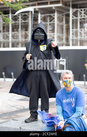 Cardiff, Wales, UK. 3rd Sep 2020. Extinction rebellion protestors outside the BBC on the third day of actions in Cardiff, 3rd September 2020. Protesters urge the BBC to tell the truth. A protestor dresses like the grim reaper Credit: Denise Laura Baker/Alamy Live News