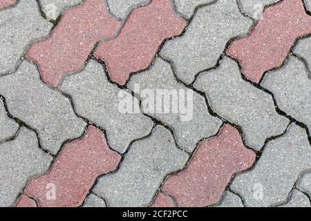 road paved with sidewalk tiles. beautiful brick background with, masonry texture of light brown and gray bricks. outdoor closeup Stock Photo