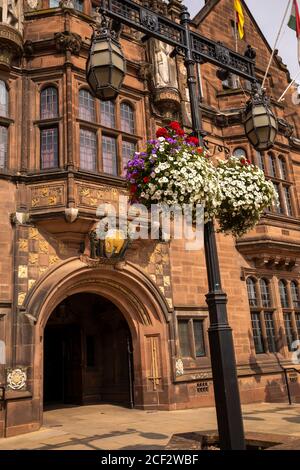 UK, England, Coventry, hanging baskets outside Council House, early C20th Tudor style civic building, floral display at entrance doorway, Stock Photo