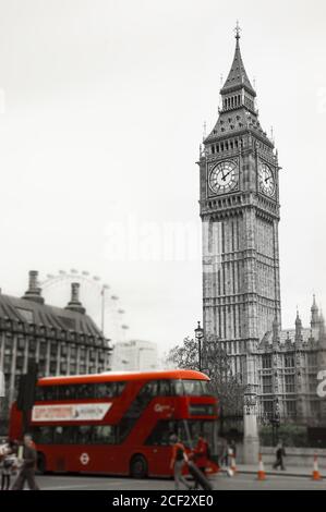 Big Ben and red double decker bus, tourists and London Eye. (London, UK). Retro aged photo. Blurred photo with selective focus on Big Ben tower. Stock Photo