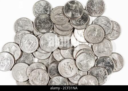 Close up of a pile of US quarters on white background Stock Photo