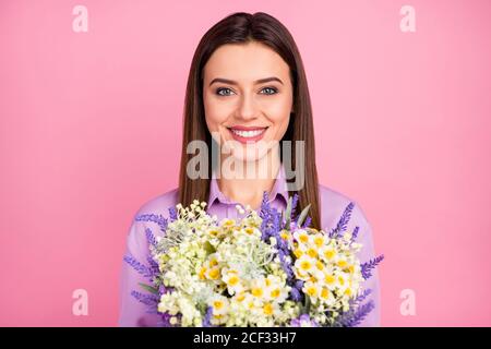 Close-up portrait of her she nice attractive lovely pretty charming winsome cheerful cheery long-haired girl holding in hands fresh natural flowers Stock Photo