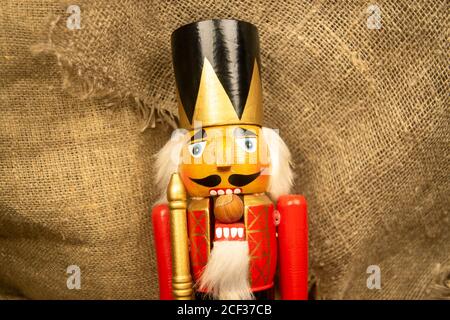 Nutcracker wooden figure of a soldier for cracking nuts. Traditional symbol of Christmas and New Year. Close up Stock Photo