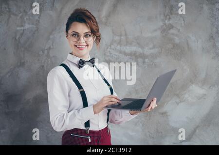 Profile side view portrait of her she nice attractive pretty content cheerful cheery wavy-haired girl using laptop working remotely self developing Stock Photo