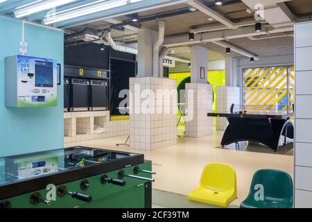 The Hague, The Nederlands, Europe, automatic laundry machines in the open space with ping pong and pool table at the Student Hotel in the city Stock Photo