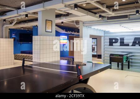 The Hague, The Nederlands, Europe, automatic laundry machines in the open space with ping pong and pool table at the Student Hotel in the city Stock Photo