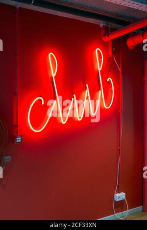 "Club" red sign with neon light on a wall Stock Photo