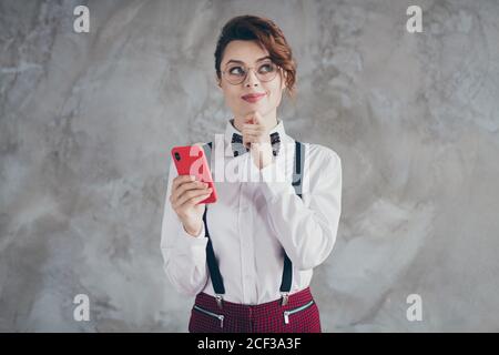 Portrait of her she nice-looking attractive lovely pretty cute creative minded brainy cheery wavy-haired girl using cell creating smm strategy Stock Photo