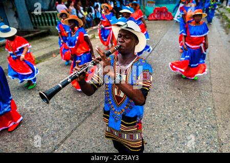 An Afro-Colombian clarinet player of the Pandeyuca neighborhood performs during the San Pacho festival in Quibdó, Colombia. Stock Photo