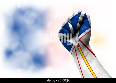 Flag of Newfoundland and Labrador painted on male fist, strength,power,concept of conflict. On a blurred background. Stock Photo