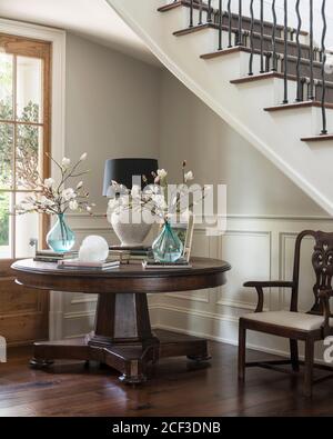 Flowers on wood table in hallway Stock Photo