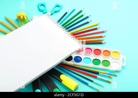 A set of school supplies for learning and creative development on a cyanide background. Stock Photo