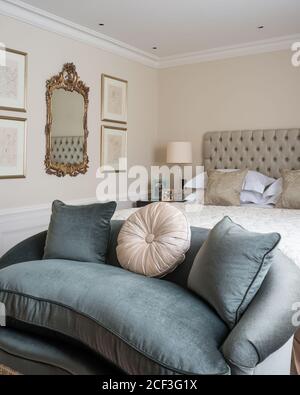 Sofa by bed in Georgian style bedroom Stock Photo