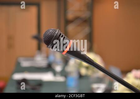 Microphone turned on on a table with a close-up in a conference room with a blurry background Stock Photo