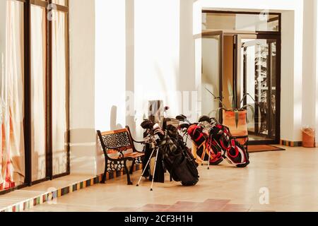 Set of golf clubs and equipment awaiting in front hotel or golf club for lifestyle design. Sport leisure lifestyle concept. Summer vacation. Stock Photo