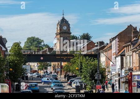 Hungerford, Berkshire, UK. View of the High Street with the Town Hall and Corn Exchange and Railway Bridge on a busy day Stock Photo