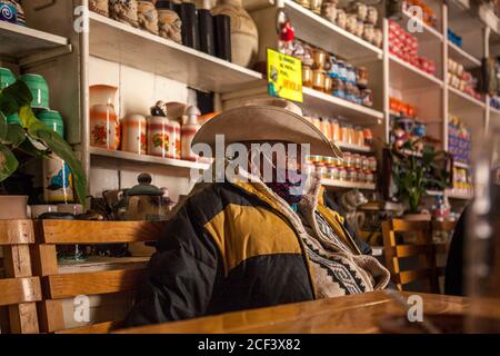 Real De Catorce, San Luis PotosÃ, Mexico. 21st June, 2020. An old man wearing a face mask as a precaution, working in a restaurant.Even though the number of visitors is not comparable with those before the Covid-19 pandemic, Real de Catorce in San Luis PotosÃ- State has slowly began to restart the economy, especially where tourism is the main source of income. Credit: Antonio Cascio/SOPA Images/ZUMA Wire/Alamy Live News Stock Photo