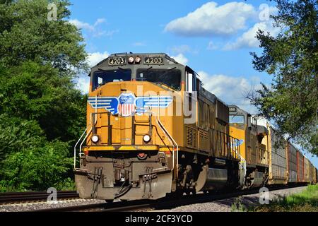 La Fox, Illinois, USA. Two Union Pacific locomotives lead an auto rack train through LaFox, Illinois on its westward from journey Chicago. Stock Photo