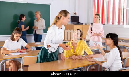 Students talking and having fun, spending time together during recess between lectures in auditorium Stock Photo