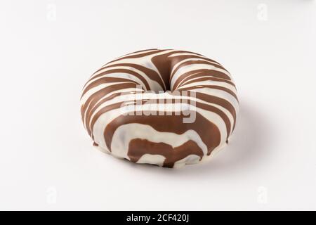 Whole tasty sweet chocolate glazed donuts stacked on white background Stock Photo