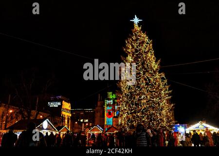 Lviv, Ukraine - December 27, 2019: Historic Ukrainian Lvov city in old town with people by Christmas tree on Svobody Avenue Stock Photo