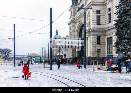 Lviv, Ukraine - December 28, 2019: Lvov in winter with people at train station and winter snow weather with trolley tram tracks Stock Photo