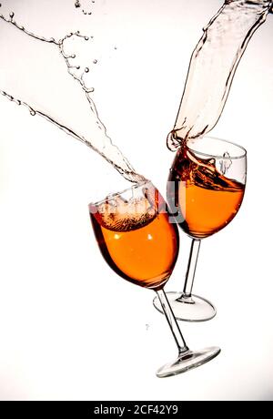 Red wine in glasses with splashes on a white background isolated Stock Photo