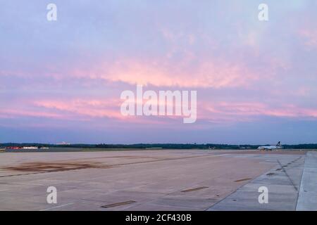 Dulles, USA - June 13, 2018: Dulles International Airport, IAD with Icelandair airplane during colorful pink blue sunset with view of air field Stock Photo