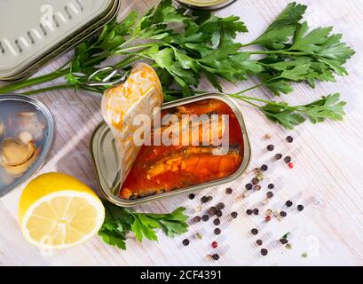 Cans of preserves with clams and fish, different opened and closed canned seafoods on background Stock Photo