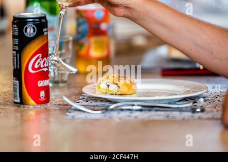 Florence, Italy - August 30, 2018: Firenze Centrale Mercato central market with closeup of dining table with traditional dessert cream pastry food and Stock Photo