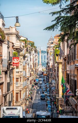 Rome, Italy - September 4, 2018: Historic city with church Santissima Trinita dei Monti column tower vertical view by Spanish Steps between buildings Stock Photo