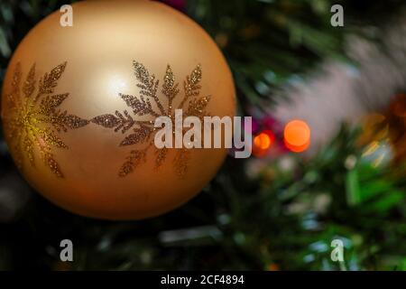 Christmas ball with snowflake glitter pattern, hanging on christmas tree with blured copy space Stock Photo