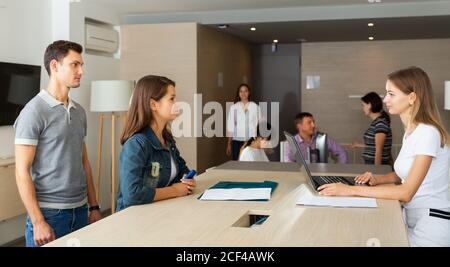 cheerful young male and female managers having meeting in office Stock Photo