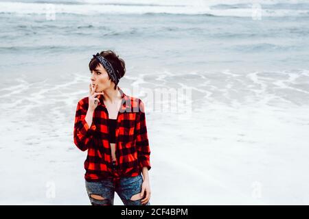 Woman smoking cigarette on beach Stock Photo