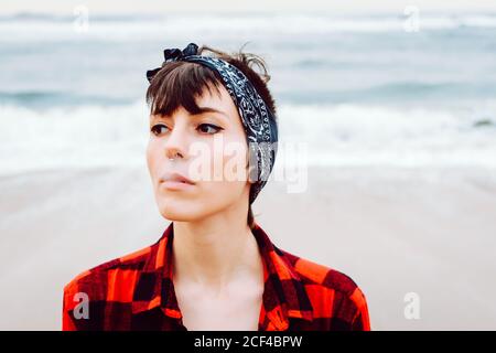 Woman smoking cigarette on beach Stock Photo